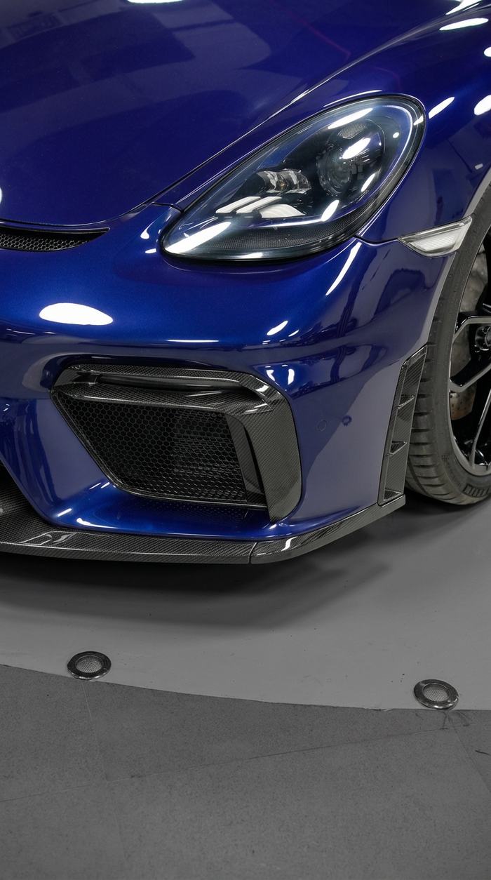 Modern sports car headlight and carbon front splitter detail